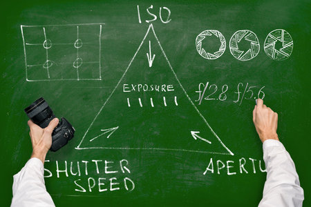 Man photographing chalk drawn illustration set of still life education objectsの写真素材