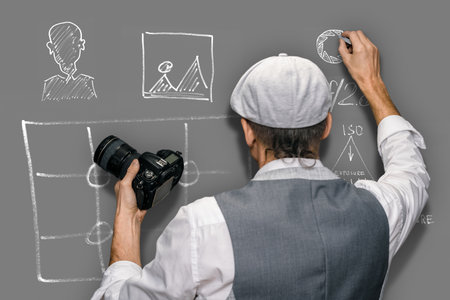 Male teacher showing how to improve photography skills during educational lessonの写真素材