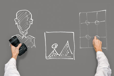 Chalkboard illustrations with educational courses and male hands with photo cameraの写真素材