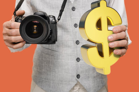 Closeup of man with digital camera earning money from photography isolated on red background, and...