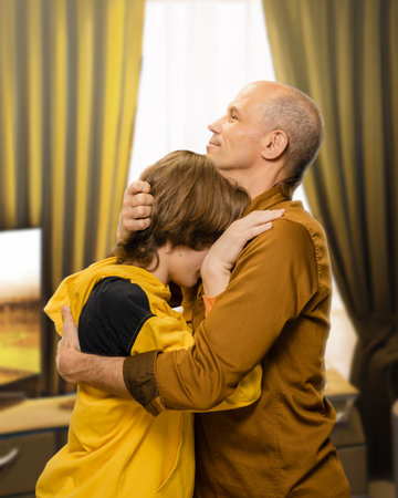 Portrait of loving dad hugging his teenager son, Affectionate embrace: Father envelops his teenage son, radiating love in a heartwarming portrait.の写真素材