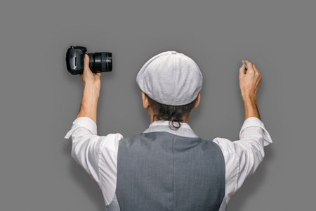 Qualified male photographer giving training program for photographers on gray backgroundの写真素材