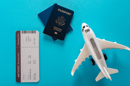 Travel preparation concept of toy airplane, flight ticket and US passportの写真素材