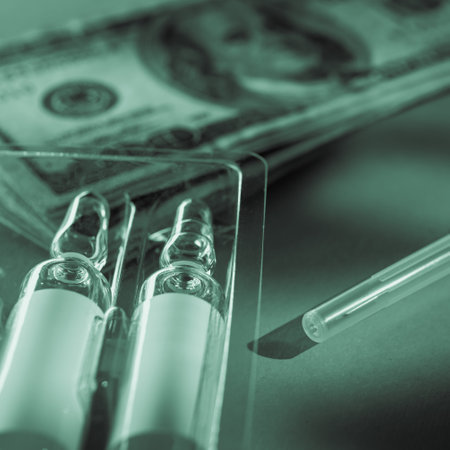 US currency money, ampoules and syringe for vaccination against virus monochrome with green tintingの写真素材