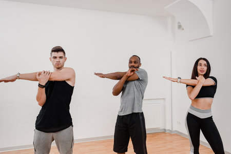 Multiethnic strong healthy people working out together at fitness club, Fitness club scene showcases...