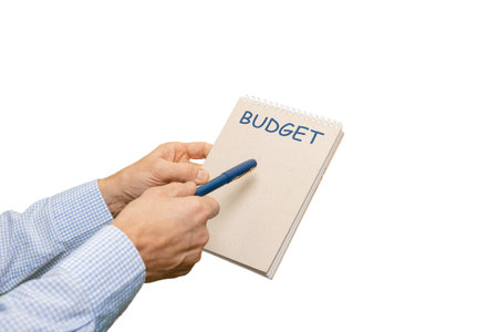 Man with planning notebook doing optimization of financial expenses isolated on white, ready to be filled with a well-thought-out monthly budget plan tailored to his unique circumstances.の写真素材