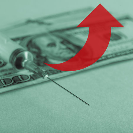 Medicine syringe and money dollar banknote in monochrome with green tinting and a red arrowの写真素材