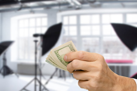 Professional male photographer getting payment for photo session, The composition juxtaposes the...