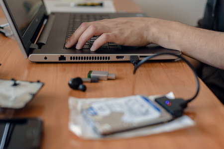 Process of installing laptop hard drive disk and data transfer, Precision installation: Technician...