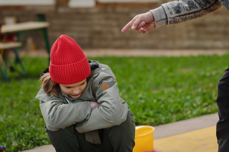 Upset teenager boy getting scolding from his strict father, Parental guidance: Strict father addresses issues with his upset teenage sonの写真素材