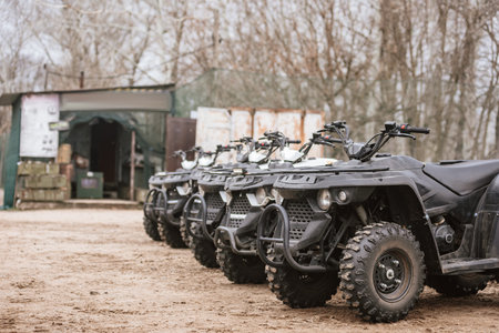 Several ATV quad bikes parked in a row ready for extreme trip. Quad bike fleet: Group of ATVs parked together, ideal for off-road enthusiastsの写真素材