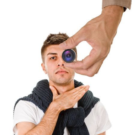 Young guy having health problem, male hand holding mini spy camera in the foregroundの写真素材