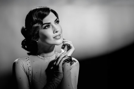 Monochrome styled photo of beautiful young fashionable lady posing. Girl in black and white retro...