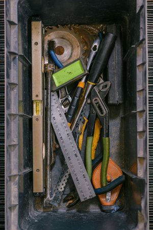 Top view of plastic box with appliance fixing tools. Toolbox with repair tools neatly arranged on a flat surface, essential equipment for home maintenance.の写真素材