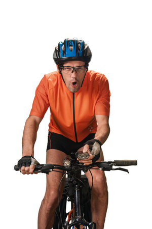 Excited man bicycle rider in helmet. Outdoor cyclist carrying pet safety accessories, including ultrasonic dog repellerの写真素材