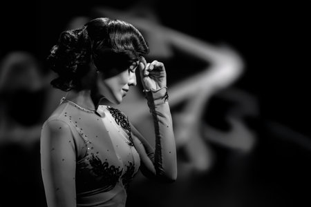 Pretty sensual woman in elegant evening dress, black and white photography in retro style. Woman in classic black and white retro style with waved hair and timeless facial featuresの写真素材