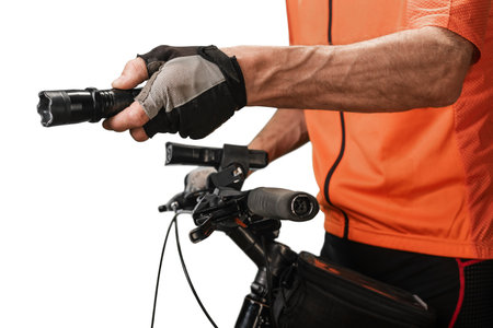 Closeup of professional sportsman using stun gun for self defense during bicycle ride. Cyclist with dog deterrent equipment, ensuring protection from potential attacks during outdoor ride.の写真素材