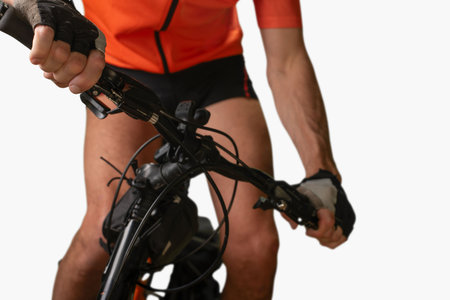 Sporty athletic man riding bicycle and falling down. Isolated cyclist falling during a ride, capturing the struggle of cycling in rugged terrain.の写真素材