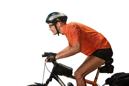 Male athletic cyclist riding bike on white background.