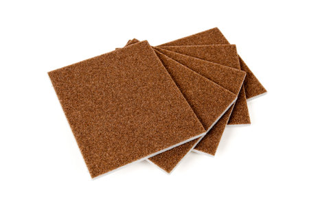 Sheets of brown abrasive sandpaper isolated on white background Coarse grit sandpaper sheets for construction and surface preparation isolated on white backgroundの写真素材