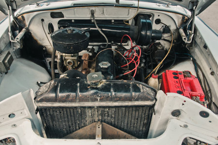 Dnepr, Ukraine - July 20, 2012: Engine compartment of retro Soviet car GAZ Volga 21 with visible red...