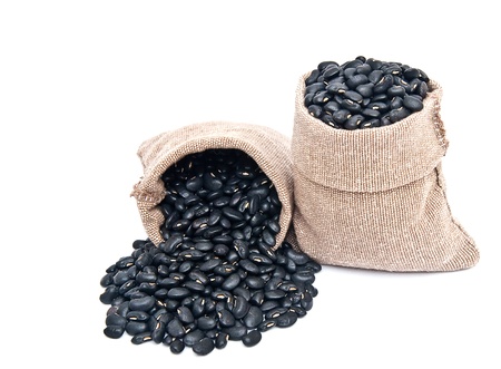 black beans in bag on white background の写真素材