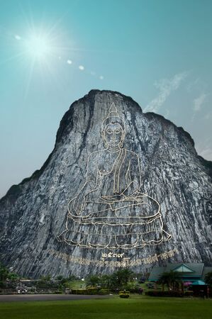 buddha image on the cliff and sun sky の写真素材
