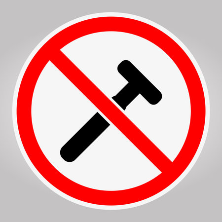 This image features a prohibition sign indicating that hammer usage is not allowed. It serves as a clear warning for safety compliance in various environments.のイラスト素材