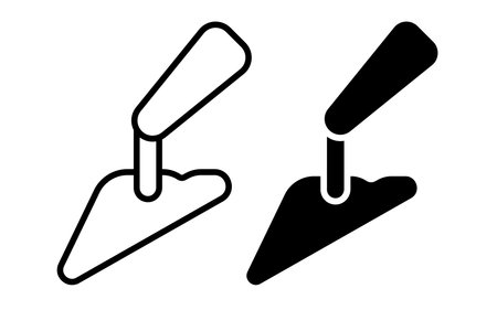 This illustration features a black and white design of a construction trowel icon suitable for various building and renovation projects.のイラスト素材