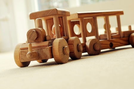 Handcrafted wooden train on an beige carpet.の写真素材
