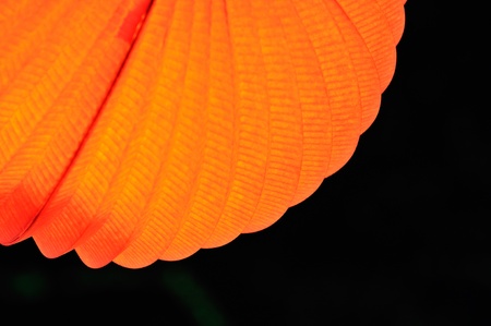chinese paper lantern in illuminating orange light at nightの写真素材