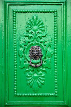 Black lion head door knocker on green door in Valletta, Malta. の写真素材