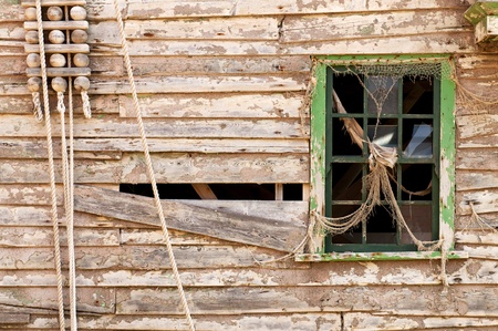 Abandoned wall with an old green coloured wooden window の写真素材