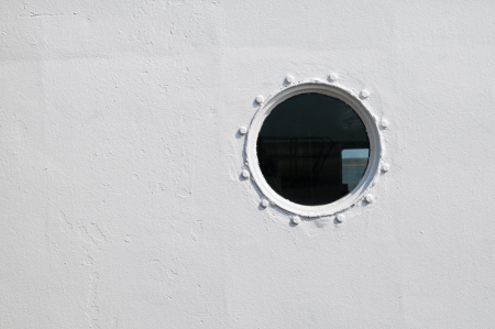A porthole window on a ships hull の写真素材