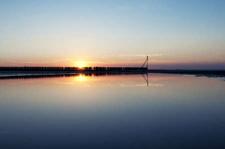 A beach photographed during a beautiful sunset, north sea region, Wangerooge, Germany  の写真素材