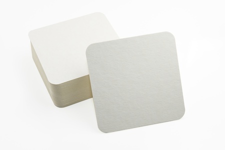 Stack of new beer coasters isolated on a white background  Add your own design  の写真素材