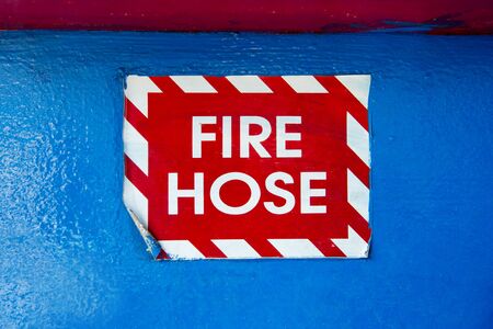 Fire hose label on blue painted backgroundの写真素材