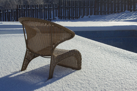 Ice swimming pool in the winter, Steps, hand-rails and garden chair in the frozen blue pool ice-holeの写真素材