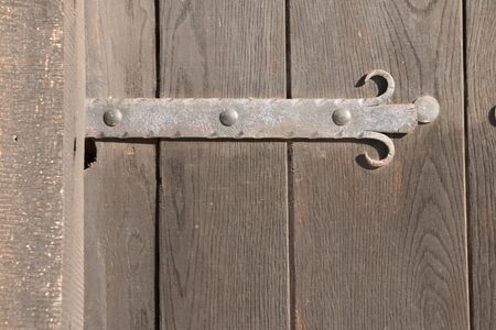 Old wooden vintage traditional door with lock, handles and hingesの写真素材