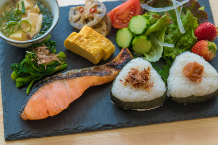 The image of breakfast. Set meal of onigiri and grilled salmon.の写真素材