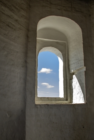 Skies in the window of ancient russian orthodox churchの写真素材