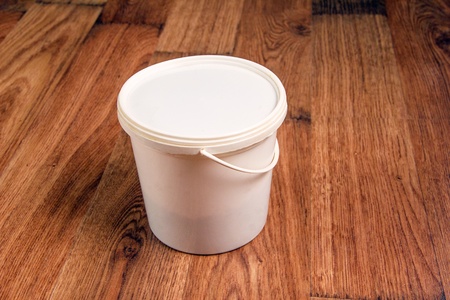 A bucket with decorating materials on laminate coverの写真素材