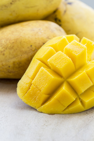 Yellow Thai mangos with a slice cut in squaresの写真素材