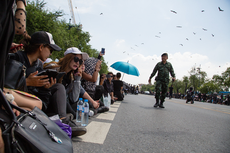 People are sitting on the road near Royal Palace, waiting body procession of his majesty king of Thailand Rama IX Phumibol Adunjadetのeditorial素材
