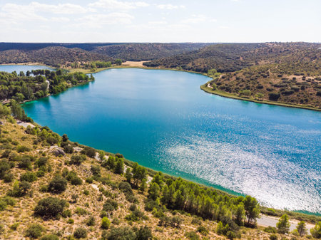 Natural Park of Lagunas de Ruidera in Spain. Panning shot through blue waterの写真素材