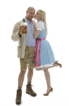 Woman in Dirndl and Man in Leather Trousers の写真素材