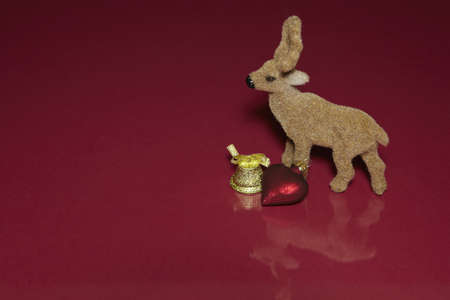 Reindeer, bell and heart with reflectionの写真素材