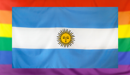 LGBT movement concept with real textile flag of Argentina placed within a blurred rainbow flag backgroundの写真素材