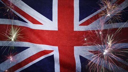 Textile flag of United Kingdom with firework grunge concept seamless close up with wind waves in the real fabricの写真素材
