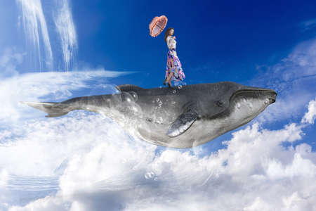 A woman with a parasol riding on the back of a giant whale walking on the back of a giant whale flying in the wide blue sky with big white clouds.3D illustration 3D renderingの写真素材